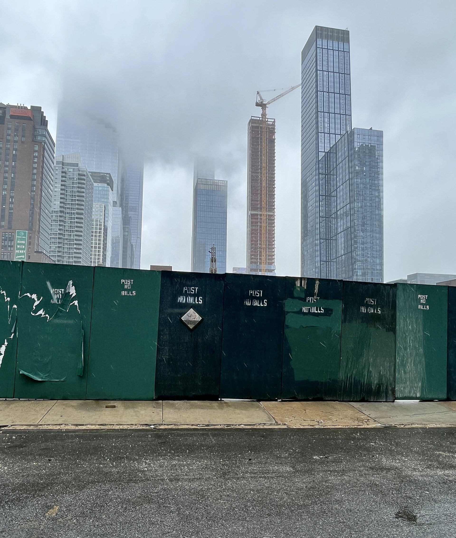 Construction fence and tower crane near West 40th Street, Manhattan